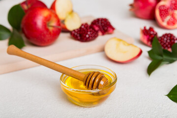 Rosh hashanah, jewish holiday, concept: honey, apple and pomegranate with cutting board, close up