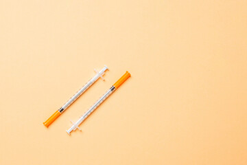 Top view of insulin syringes ready for injection on colorful background. Diabetic concept with copy space