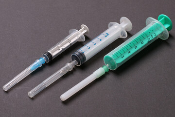 Top view of syringes in a row for medical injection on colorful background with copy space. Health and vaccination concept