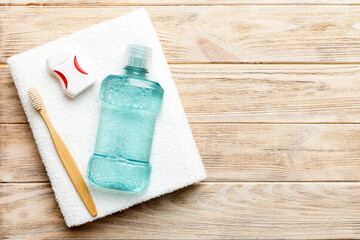 Mouthwash and other oral hygiene products on colored table top view with copy space. Flat lay. Dental hygiene. Oral care products and space for text on light background. concept