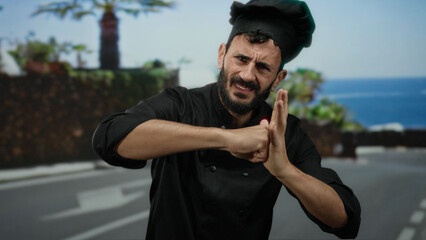 Hispanic chef in black uniform energetically gestures with fists on a sunny street, illustrating...