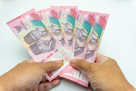 hand with rupiah money isolated on white background