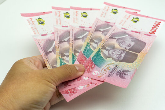hand with rupiah money isolated on white background