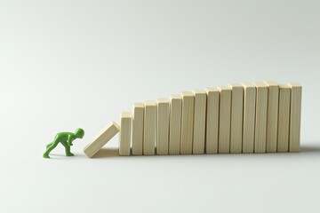 Small figurine pushing dominoes