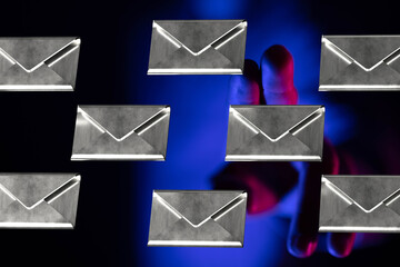 Hand choosing an email from multiple options.  Cybersecurity, data protection, and online privacy...