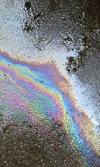 abstract background of the oil spill on the surface of the water. Selective focus