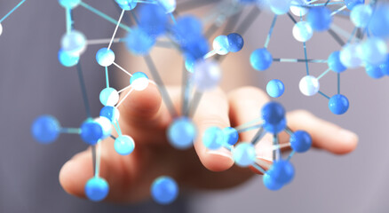 Abstract image of a hand interacting with a glowing blue molecular structure. Perfect for...