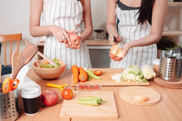 Young Women Asian Food Cooking Preparation Salad Vegetable Kitchen Lifestyle Healthy Eating, Joyful Moments of Healthy Meal Making and Togetherness in a Cozy Home Kitchen Full of Freshness and Smiles