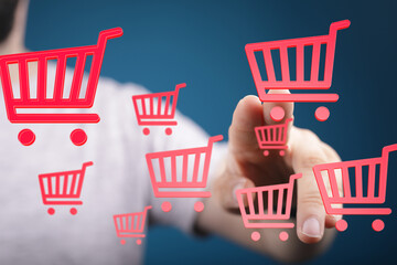 Person interacts with digital shopping carts, representing online shopping and e-commerce.