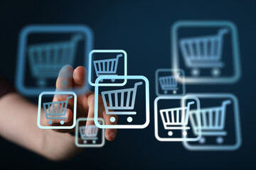 Hand interacts with digital shopping cart icons, representing online shopping, e-commerce, and...