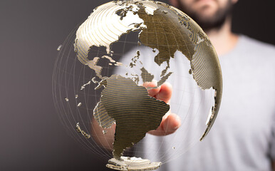 A hand interacts with a transparent globe, symbolizing global connection and networking.