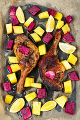 Duck roast with baked exotic fruits, baking sheet.