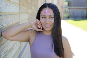 Woman with fun sparkly stones on her face 