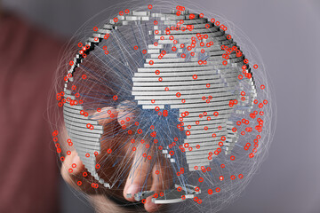 Hand interacting with a 3D model of global network connections, showcasing data points and...