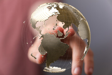 Abstract image of a hand interacting with a 3D model of the Earth, symbolizing global connectivity...