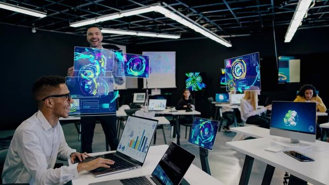 Software engineers are developing a new innovative app using augmented reality interfaces, charts, and data analysis in a futuristic office