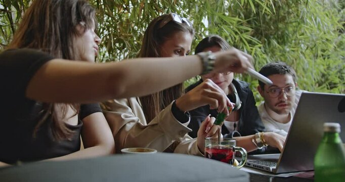 High school students collaborate on homework or exam prep at a cafe. Teamwork, friendship, and focused learning create a positive study environment. - Powered by Adobe