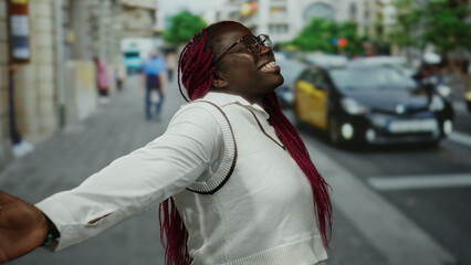 Woman smiling on city street with taxis and people in background, urban setting, depicting diverse...