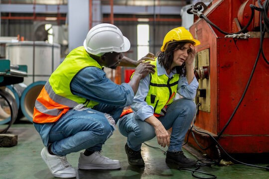 tired female worker feeling sick after stressed work in manufacturing factory, exhausted woman technician has problem working overload, male foreman support consoling and encorage at industrial plant