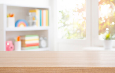 Wooden table top for educational purposes on blurred bookshelf and autumn window interior background. Original work - no AI used