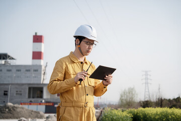 asian engineer working with digital tablet in construction site