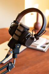 Podcast studio setup with microphone and headphones ready for live broadcast in a cozy workspace