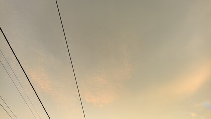 Power lines against a soft, atmospheric sky at dusk. Minimalist urban landscape with subtle colors.