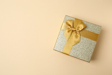 Beautiful gift box on color background, top view