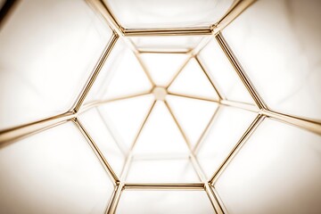 Geometric gold structure against white backdrop