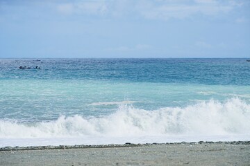 Clear blue ocean on a sunny summer day, horizon with a fishing boat