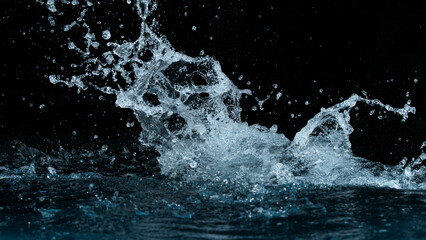 Clear water splash on a black background , close-up