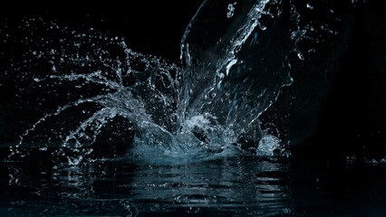 Clear water splash on a black background , close-up