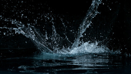 Clear water splash on a black background , close-up