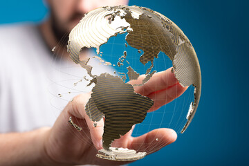 Person interacts with a digital globe, symbolizing global connection and networking.