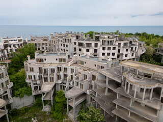 Abandoned hotel complex in Tsarevo, Bulgaria. Aerial view of decaying brutalist buildings overtaken...