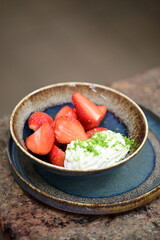 Fresh strawberries with mascarpone cheese served as fresh fruit – vibrant and creamy dessert with elegant food background