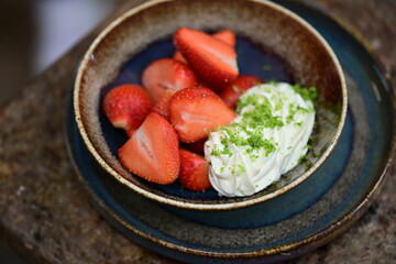 Fresh strawberries with mascarpone cheese served as fresh fruit – vibrant and creamy dessert with elegant food background