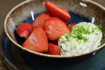 Fresh strawberries with mascarpone cheese served as fresh fruit – vibrant and creamy dessert with elegant food background