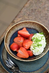 Fresh strawberries with mascarpone cheese served as fresh fruit – vibrant and creamy dessert with elegant food background