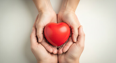 Gentle hands sharing a vibrant red heart symbolizing love care and compassion