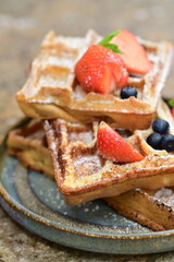 Portion of golden waffles (gofry) served on a plate, showcasing their crispy texture and inviting appearance