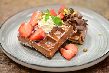 Portion of golden waffles (gofry) served on a plate, showcasing their crispy texture and inviting appearance