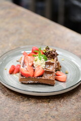 Portion of golden waffles (gofry) served on a plate, showcasing their crispy texture and inviting appearance