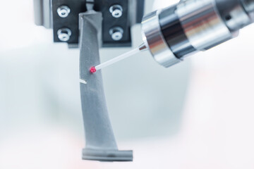 Cnc coordinate measuring machine inspecting precision part in manufacturing facility