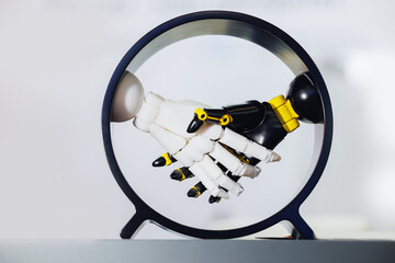 Robotic handshake between metal and plastic arms in circular frame