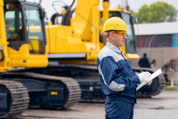 Engineer worker uses computer tablet to configure equipment. Service diagnostics and repair of...