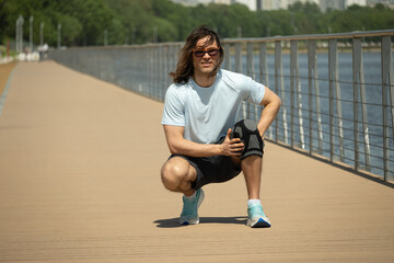 Man wearing knee brace to support painful leg. Athlete bodybuilder leg wearing knee support brace...