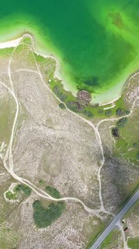 Scenic aerial drone image of a  island surrounded by white sand coastline. Chayei Island, Sevan, Armenia