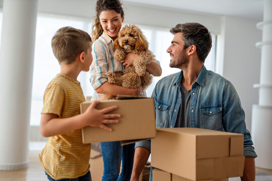 New home. Parents with child moving in new house, property mortgage and real estate investment.