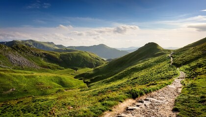 a narrow mountain path weaves through a lush green landscape bordered by rolling hills and distant peaks inviting adventure and tranquility amid nature s embrace